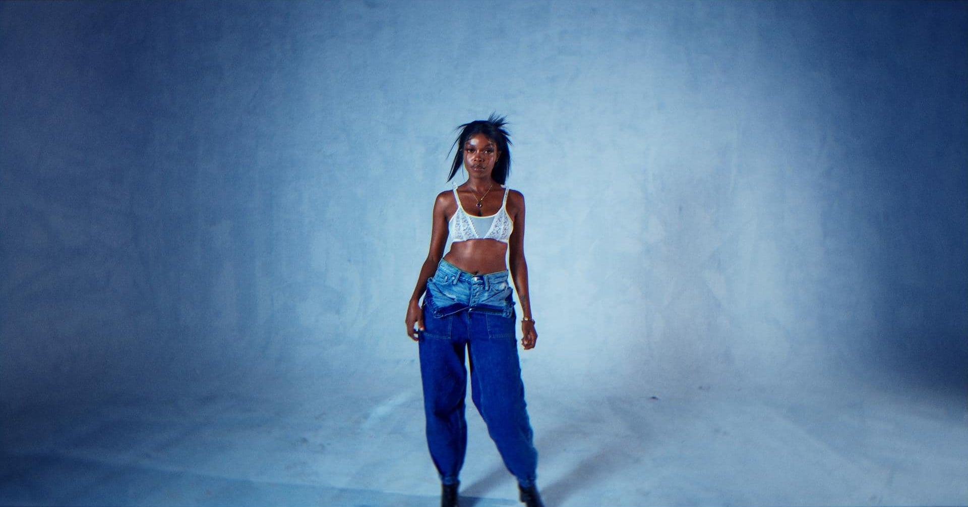 Teslah music video still: the artist in a pale blue studio